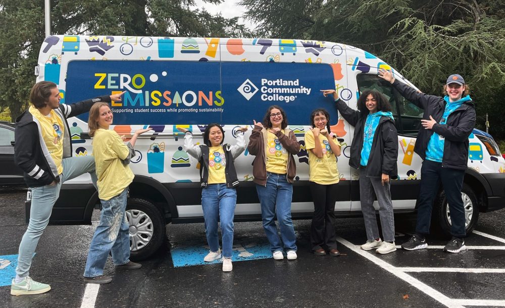 Staff in front of a PCC-branded EV van