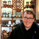 Picture of Maylorie in front of Japanese tea sets.