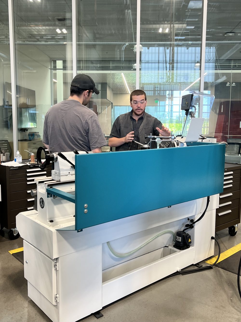 Gabe in the PCC OMIC machining shop helping a student.