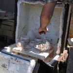 The specially-designed raku kiln is loaded with pieces that are glazed. Pieces for "naked raku" are not glazed – they will be treated after being fired to 1500 degrees Fahrenheit.