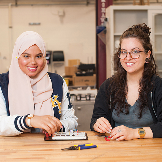 Two students working on an electronics project