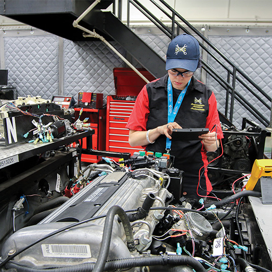 Student in the automotive service workshop working on an engine