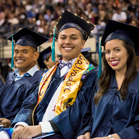 Students smiling at graduation