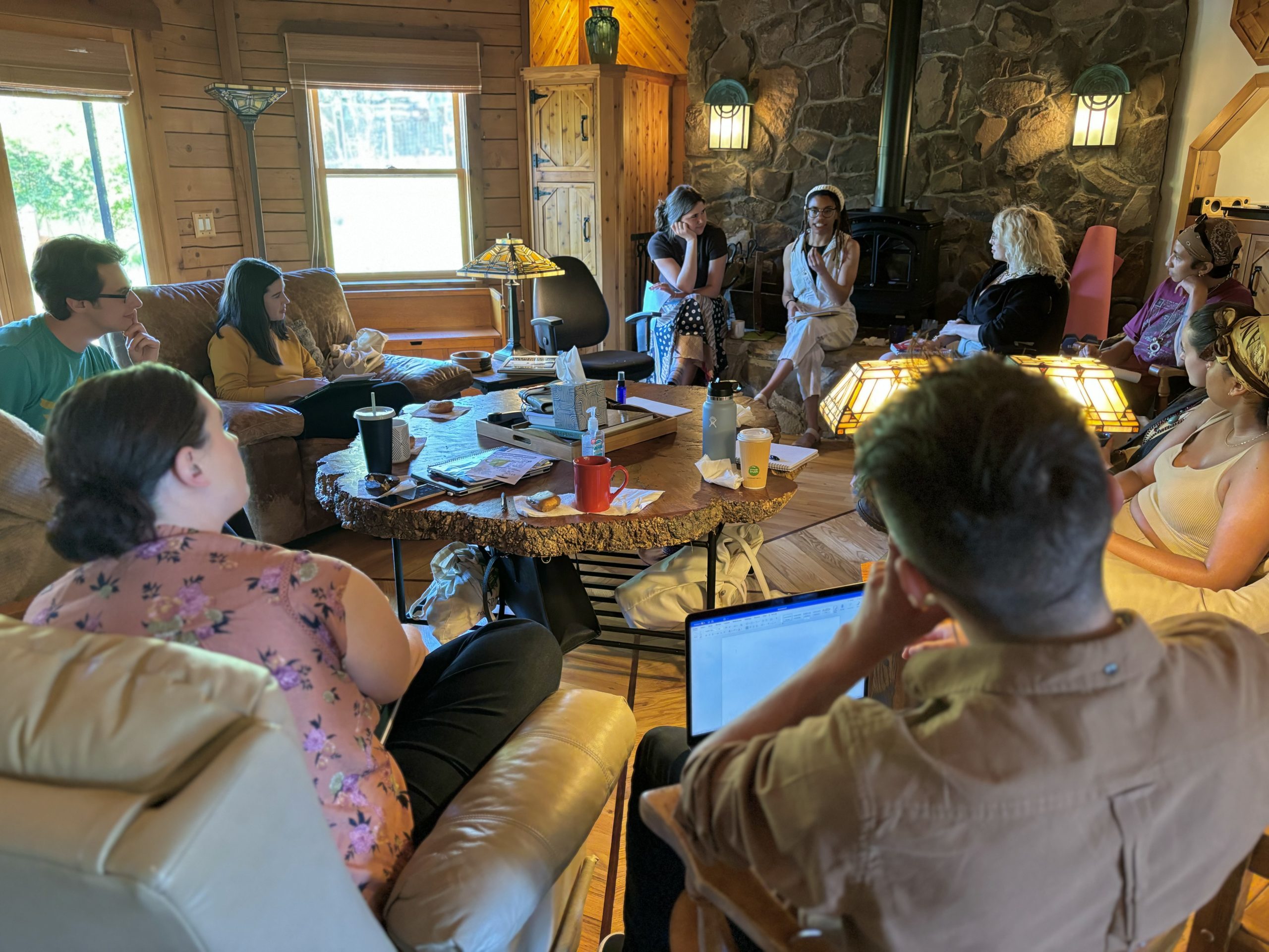 A PCC writing class visits poet Jae Nichelle at the Carolyn Moore Writing House. The students sit in a circle and look at Jae while she discusses poetry.