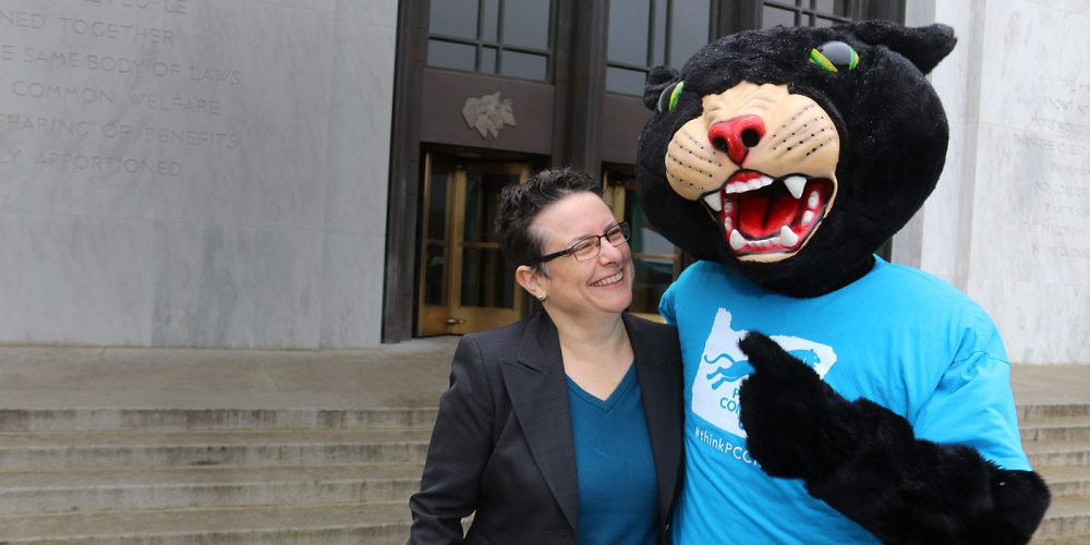 Poppiethe Panther and Lisa Avery in front of the Oregon Capitol