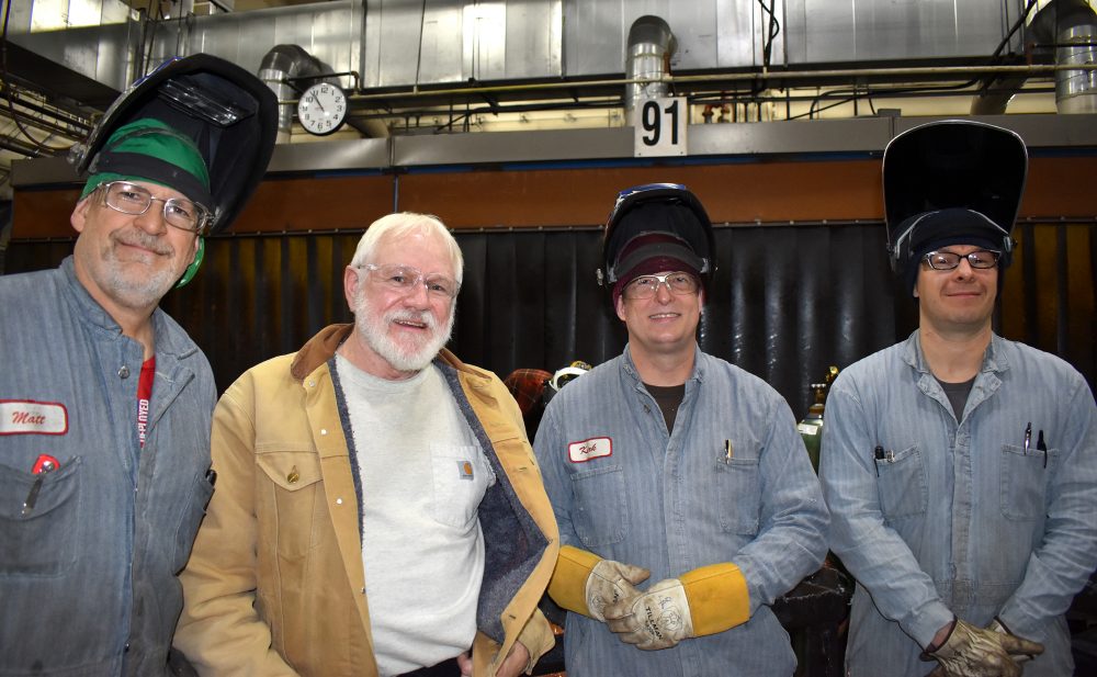 Welding faculty (left to right) Matt Scott, Scott Judy and Kirk Ebberts take a moment to pose with staffer Aaron Gardner.