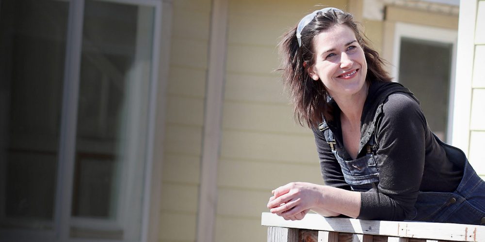 Erin Beaty leaning on a home railing