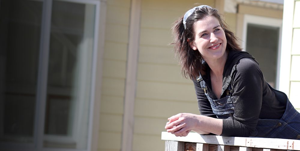 Erin Beaty leaning on a home railing.