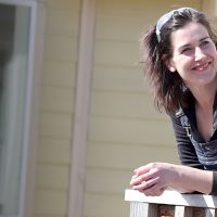 Erin Beaty leaning on a home railing.