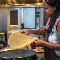 Photo of Eleni making Injera