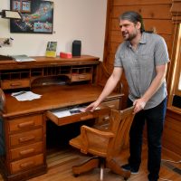 Justin Rigamonti shows off one of Carolyn Moore's favorite desks.