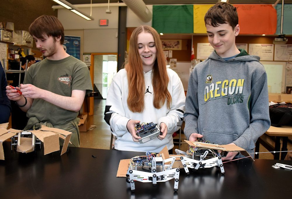 Forest Grove HS students working with robots.