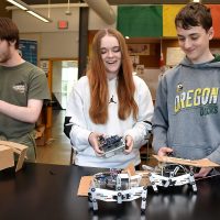 Forest Grove HS students working with robots.