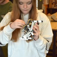 Madelyn Porter works on a battle bot.