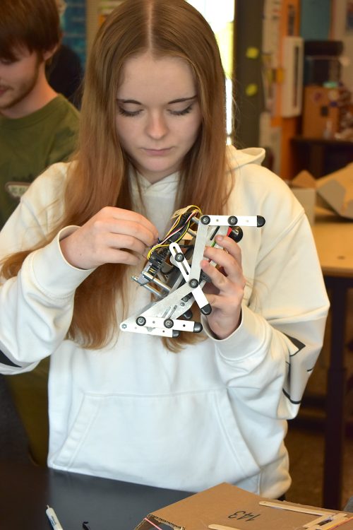 Madelyn Porter works on a battle bot.