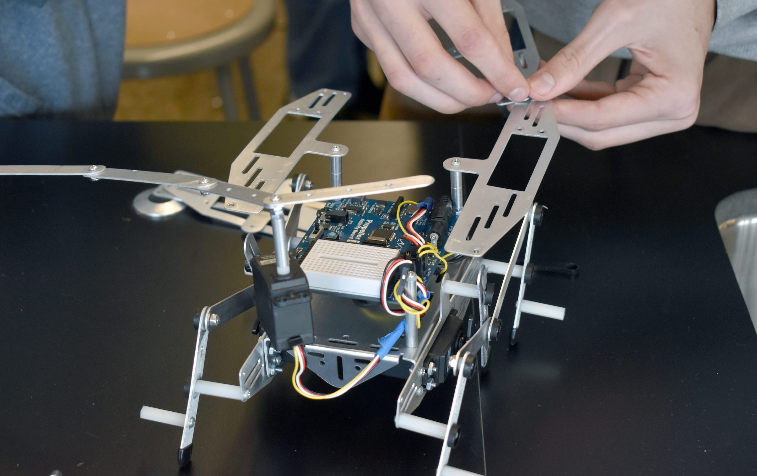 hands building a robot.