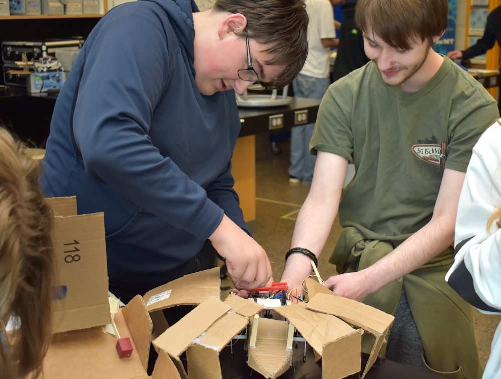 James Houx (left) is a 17-year-old junior and peer tutor for the mechatronics class.