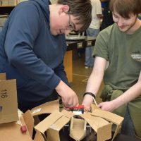 James Houx (left) is a 17-year-old junior and peer tutor for the mechatronics class.