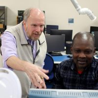 Instructor and student in EET lab