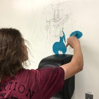 Student paitning mural outline