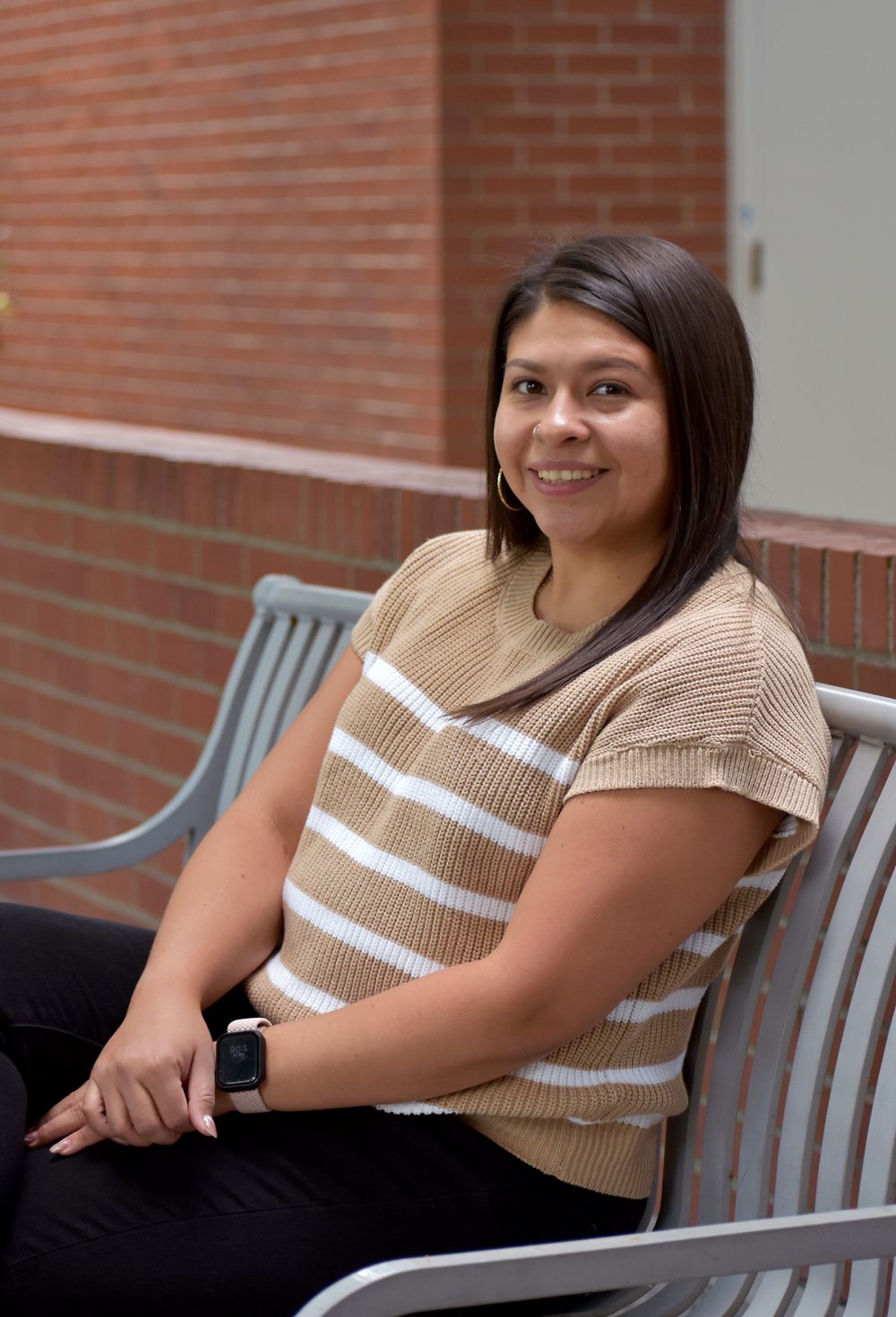 Gabby Garcia sits on bench at SE Campus