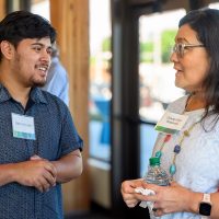 Mson Gongora chats with PCC Board Trustee Mari Watanabe.