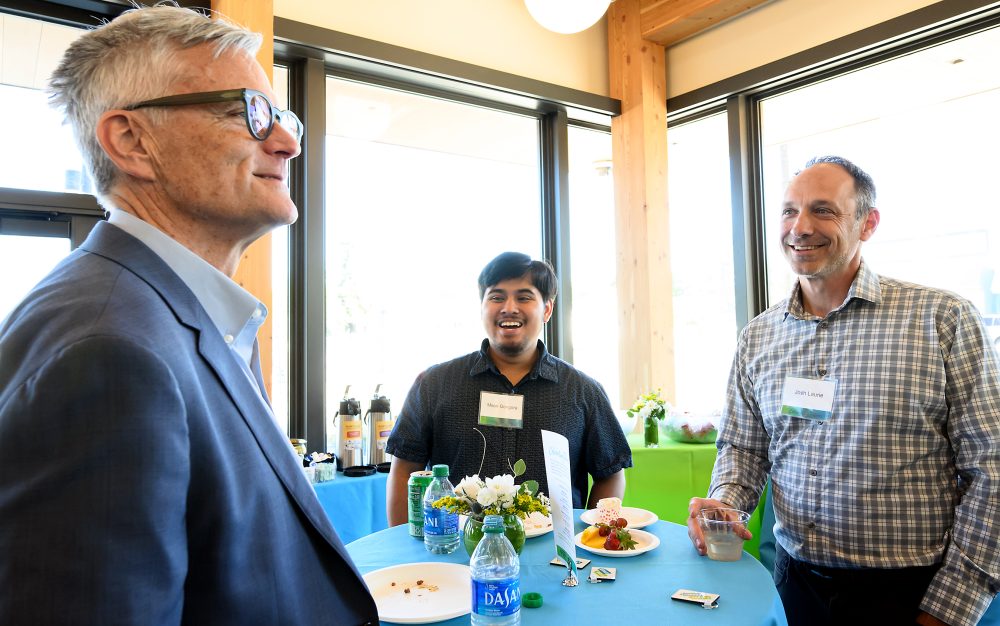 Gongora chatting with former Portland Mayor Sam Adams (left) and Director of College Success Programs Josh Laurie.