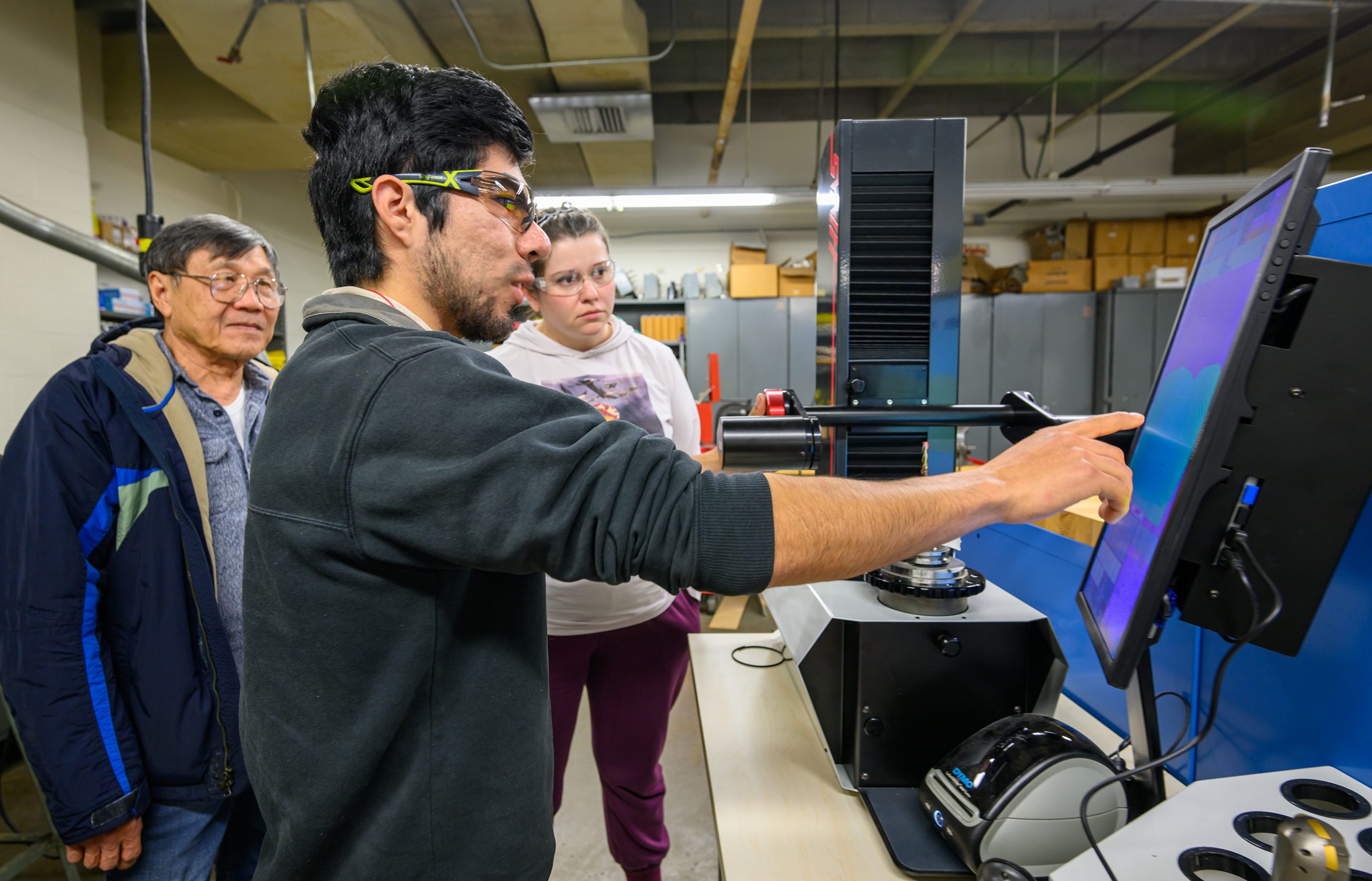 Pablo Jimenez demonstrates a CNC machine.