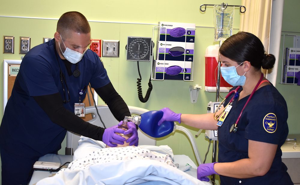 Nursing students Chris Immonen and Alena Hasson in lab.