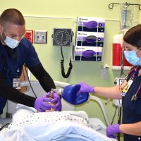 Nursing students Chris Immonen and Alena Hasson in lab.