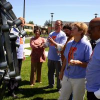 Mylan Rakich showcasing his sculpture 'Shine' to college leadership during Art Beat 2007.