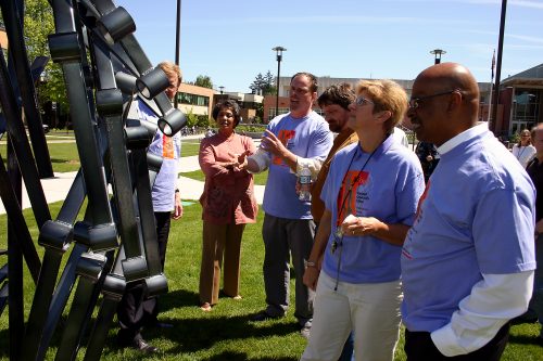 Mylan Rakich showcasing his sculpture 'Shine' to college leadership during Art Beat 2007.