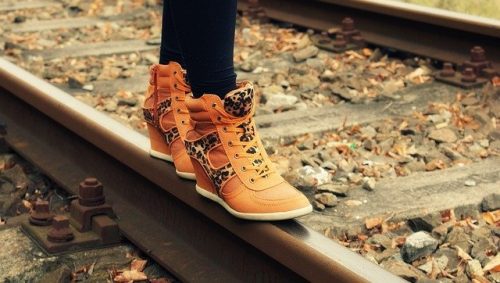 Feet balancing on a railroad track