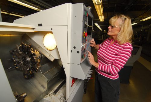 Woman using CNC machine