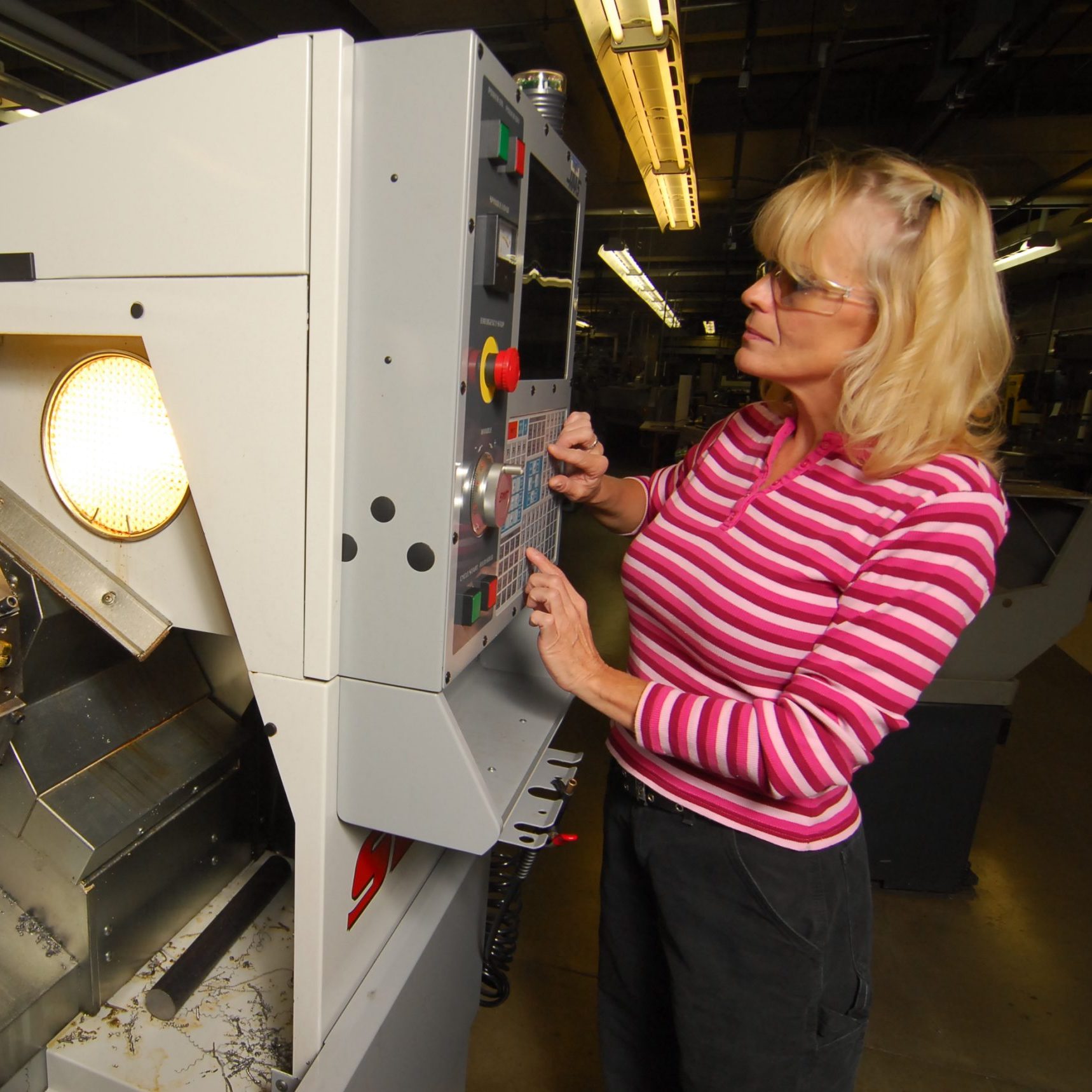 Woman using CNC machine