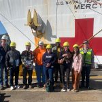 Students outside a Naval ship