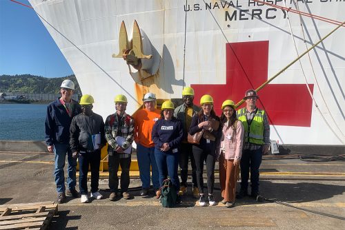 Students outside a Naval ship