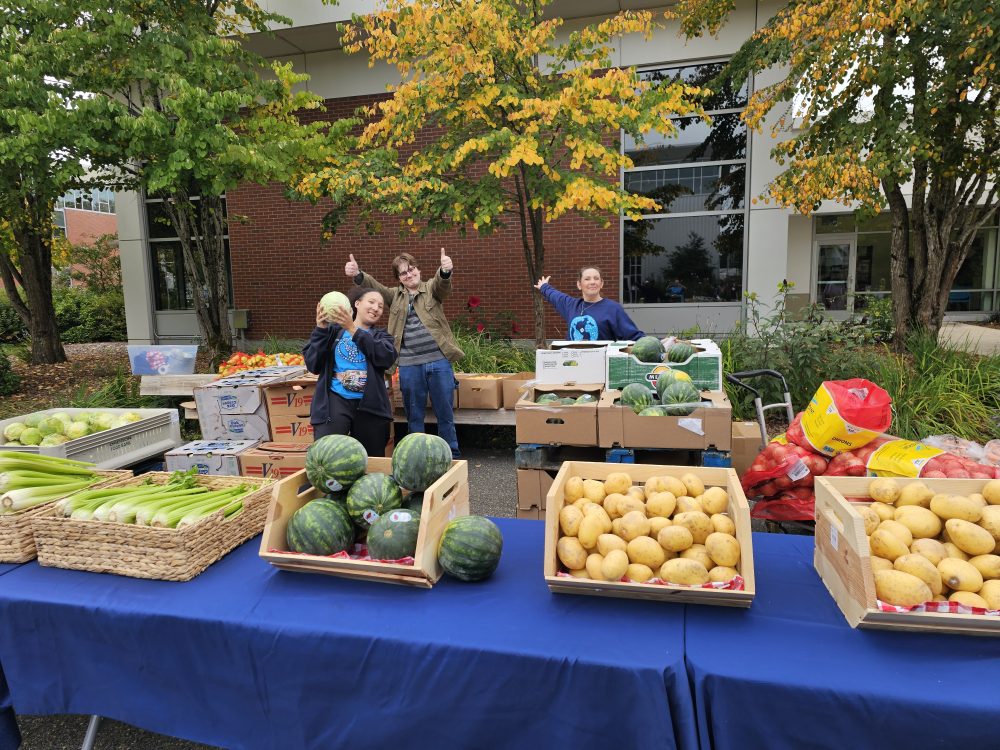 Photo of staff preparing for an outdoor Free Food Market at SE Campus