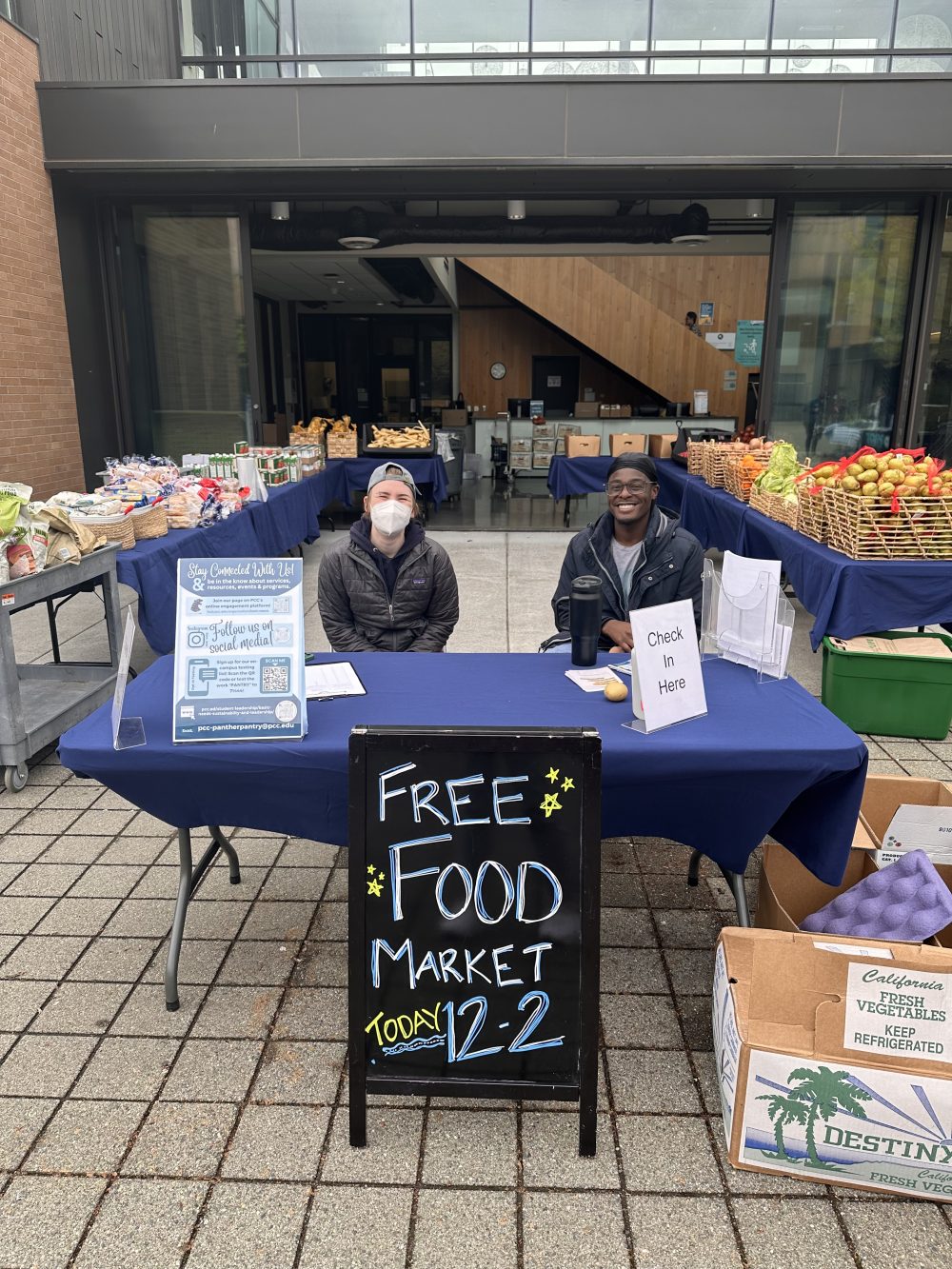 Photo of two students volunteering at the Free Food Market