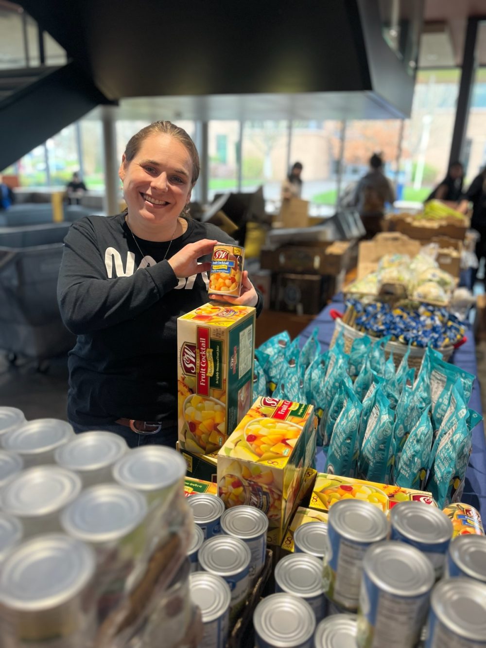 Photo of a staff member setting up a table at the free food market