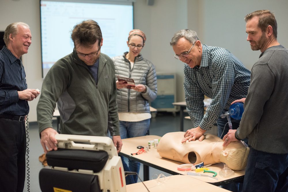 AHA and Cardiology students practice using mannequins in CLIMB classroom