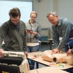 AHA and Cardiology students practice using mannequins in CLIMB classroom