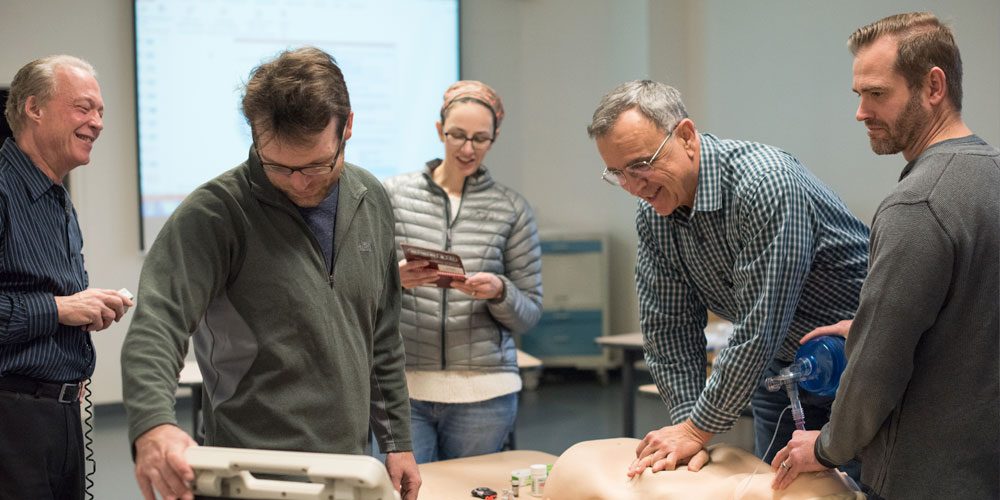 AHA and Cardiology students practice using mannequins in CLIMB classroom