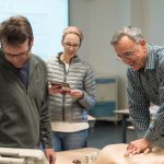 AHA and Cardiology students practice using mannequins in CLIMB classroom