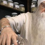 Instructor KP Khalsa stands in herbalism storeroom