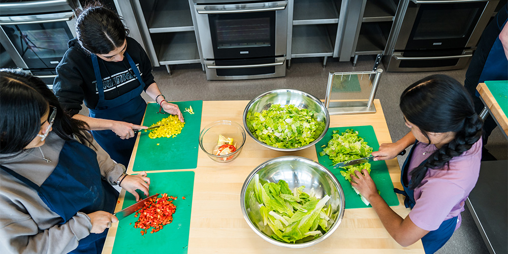 Students slicing vegetables