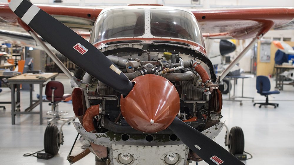 Front of an airplane with the propeller and engine showing