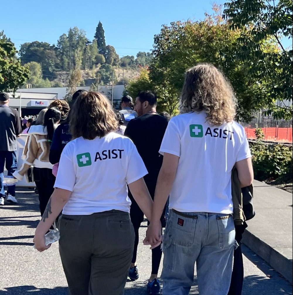 Students walking together with ASIST shirts on