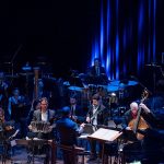 John Mery playing during an orchestra performance