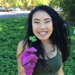 Student holding four leaf clover